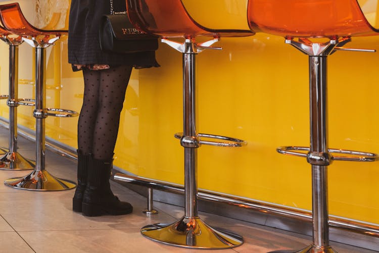 Legs Of Woman In Tights Standing By Bar Counter