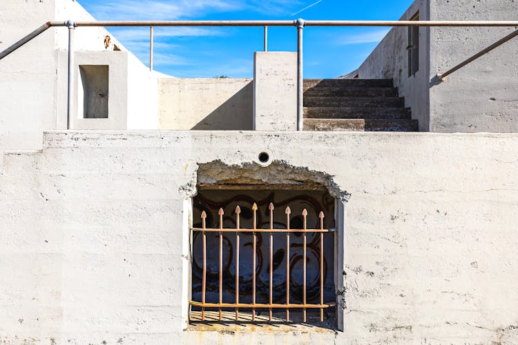 Sunlit Building Wall With Bars