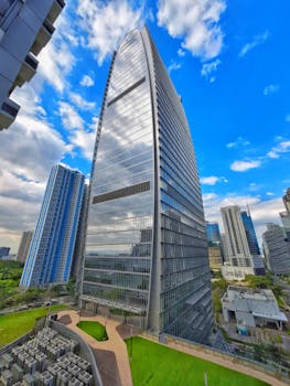 Capture of a sleek skyscraper against a clear sky, showcasing modern architecture.