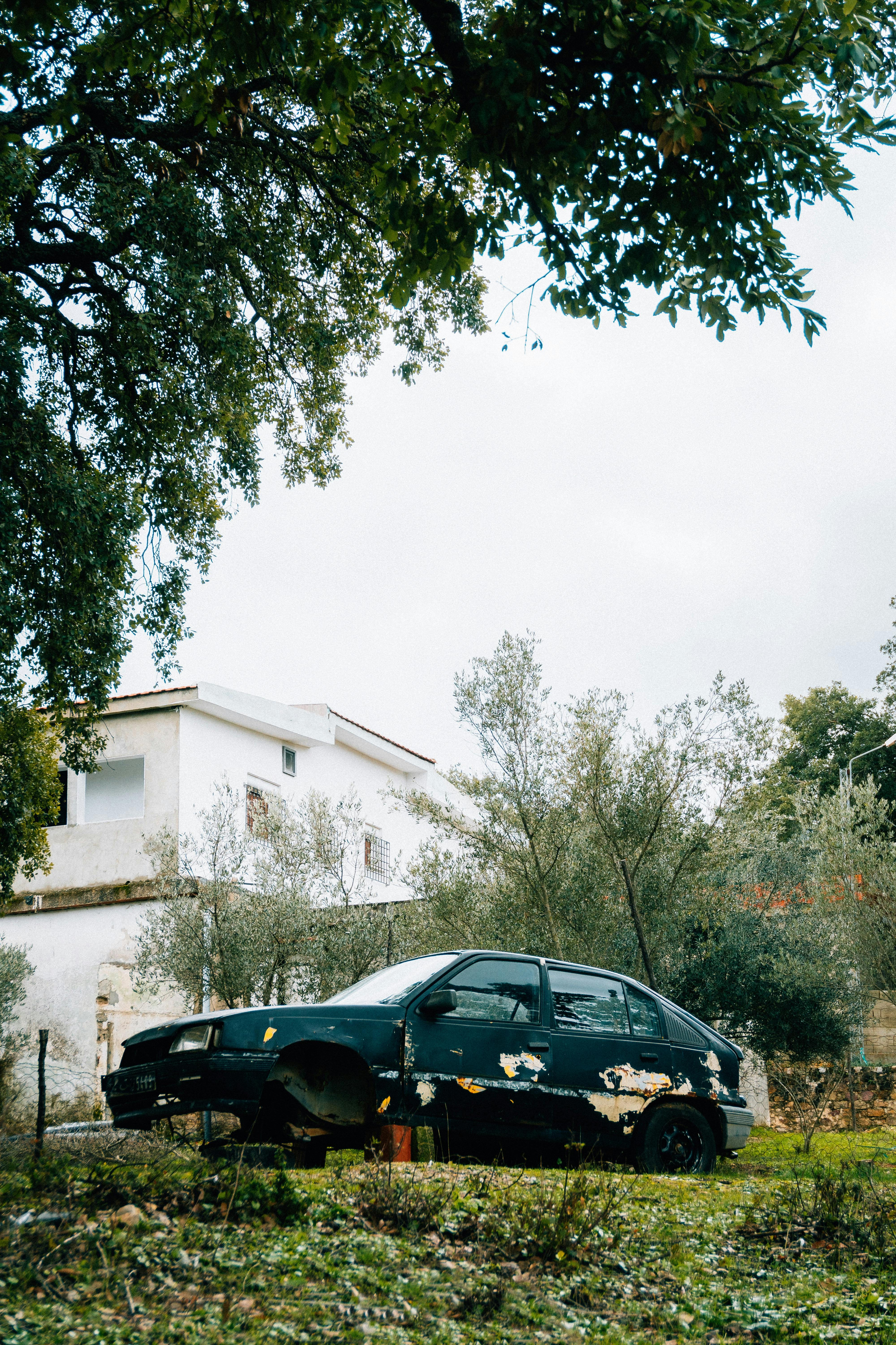 An Old Abandoned Car without Front Wheels · Free Stock Photo