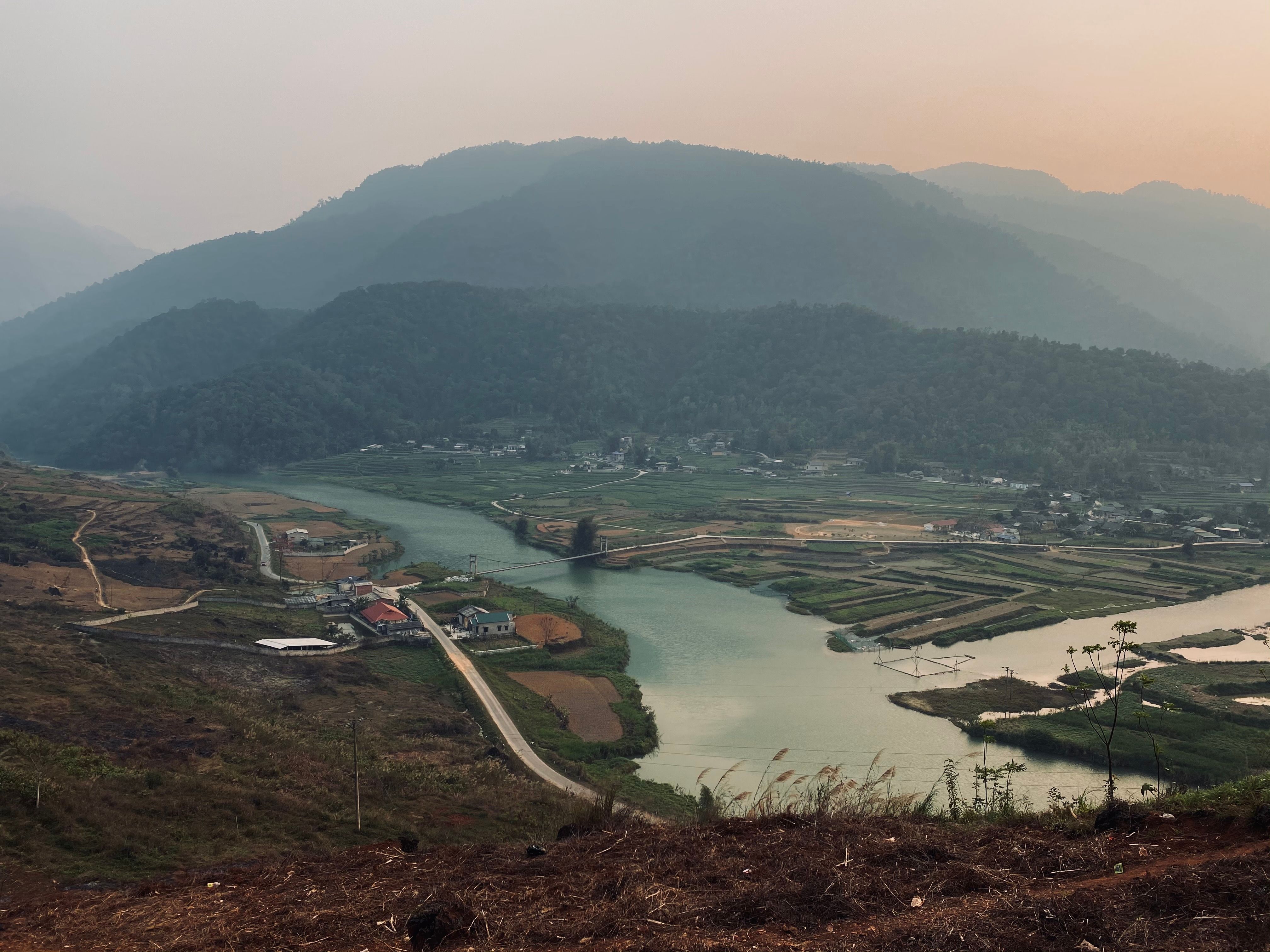 Stunning aerial landscape of Ha Giang, Vietnam with river, fields, and mountains.
