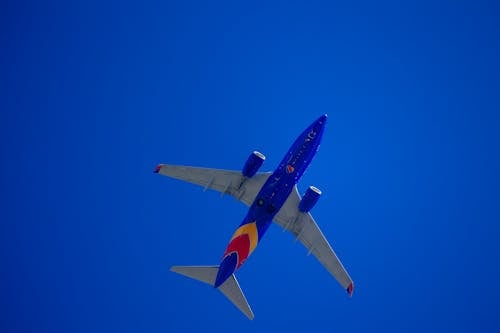 Commercial Airplane Flying against Blue Sky