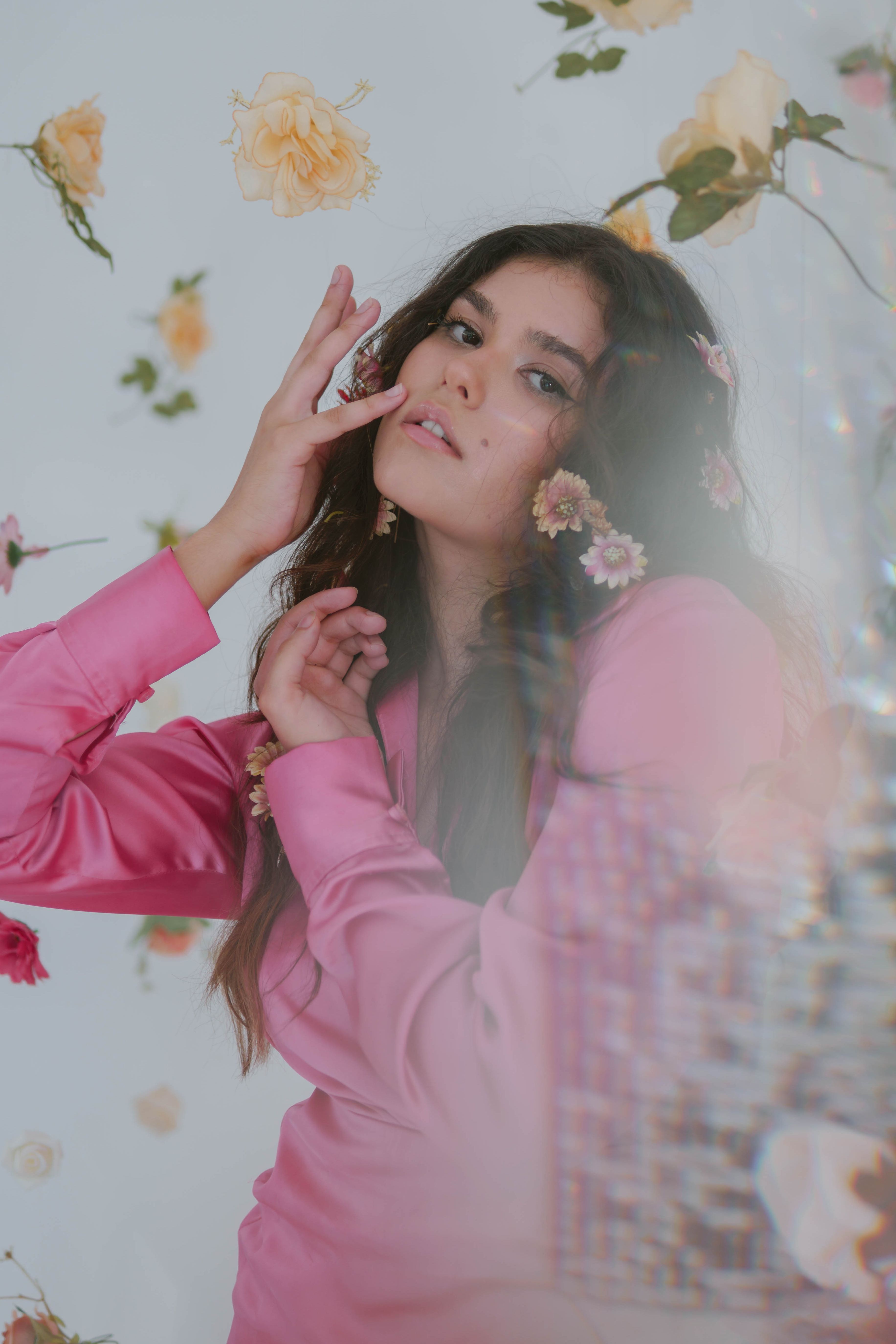 Young Brunette in a Pink Dress Posing in a Studio among Flower ...