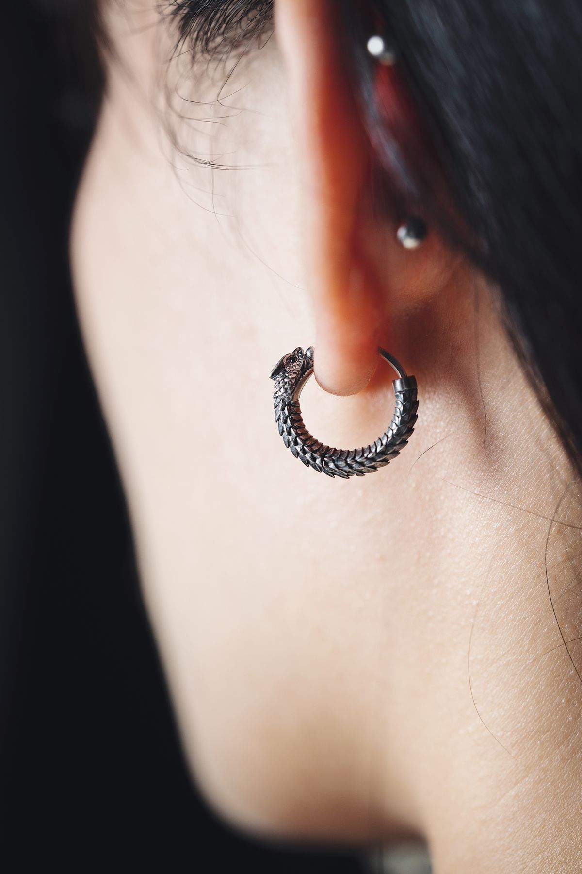 A plain silver hoop worn, photographed close