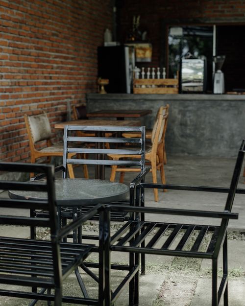Free A charming café interior with industrial design, featuring a bar area and rustic seating. Stock Photo