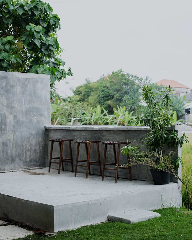 High Stools On A Concrete Patio 