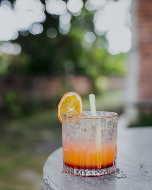 Free Chilled cocktail with orange slice and ice, perfect for a summer day. Stock Photo