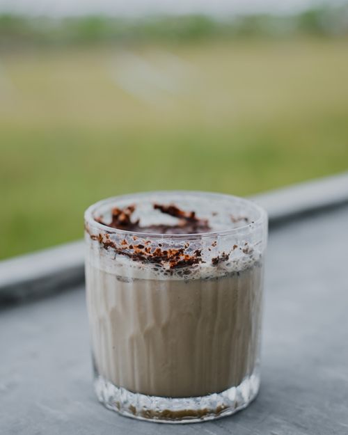 Free A delicious creamy coffee with rich foam and chocolate topping served in a glass cup. Stock Photo