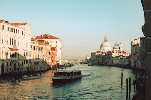View of a Boat on Canal Grande and the Santa Maria della Salute Church in the Background, Venice, Italy 