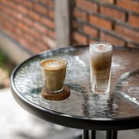 Latte and iced coffee on a café table — Arya Bajra on Pexels
