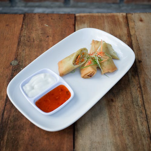 Spring Rolls with Sauces on Plate on Table