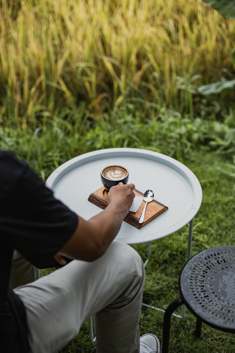 Man Drinking Coffee In A Cafe Patio 