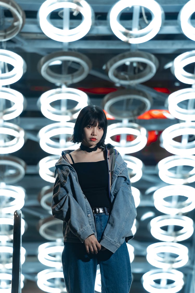 Teenager Girl Standing Under Lamps