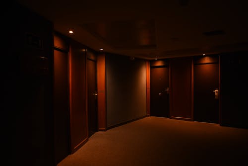 Dark Hotel Corridor with Doors to the Rooms 