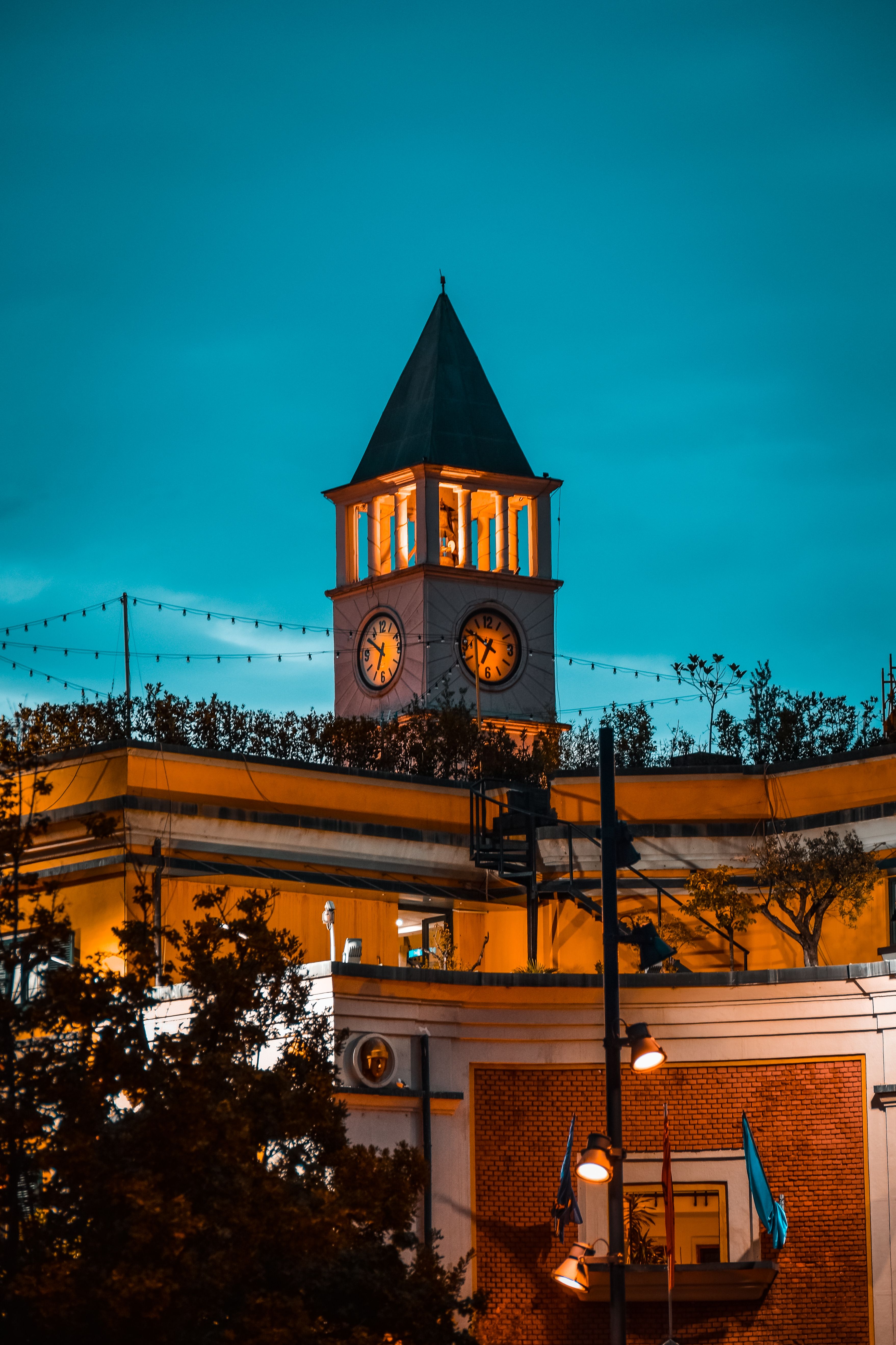 Illuminated Stone Building with Tower on Night Sky · Free Stock Photo