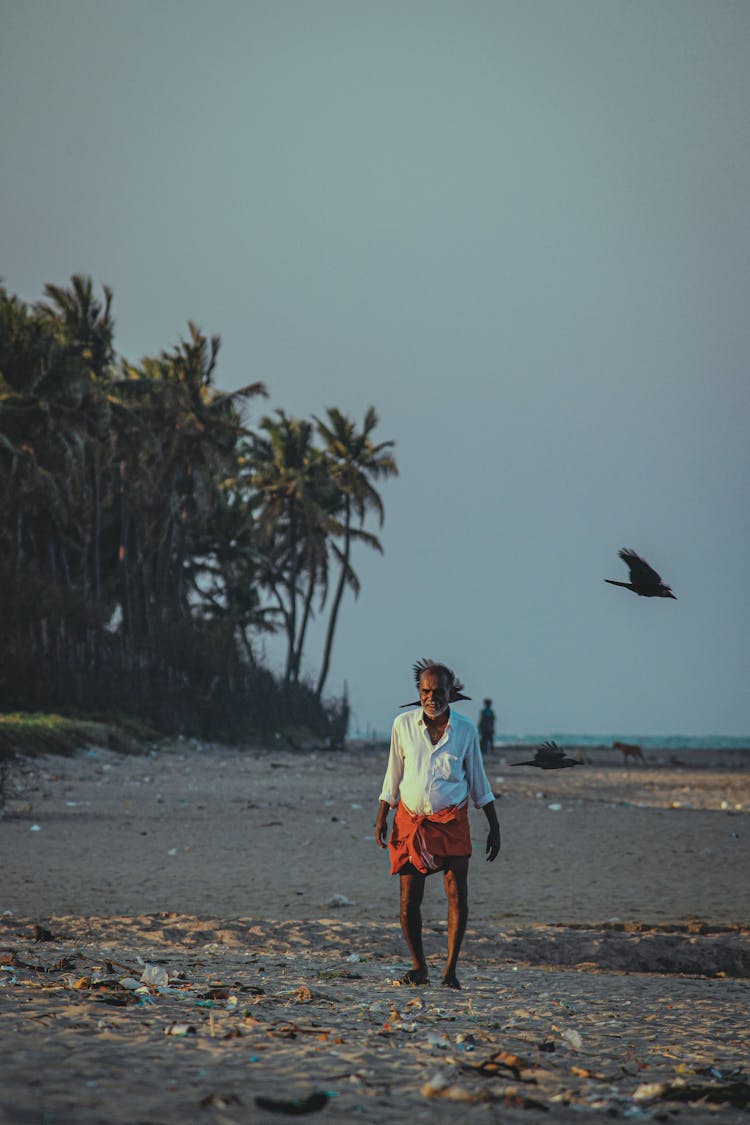 Old Man Walking Sand Beach On Sunset