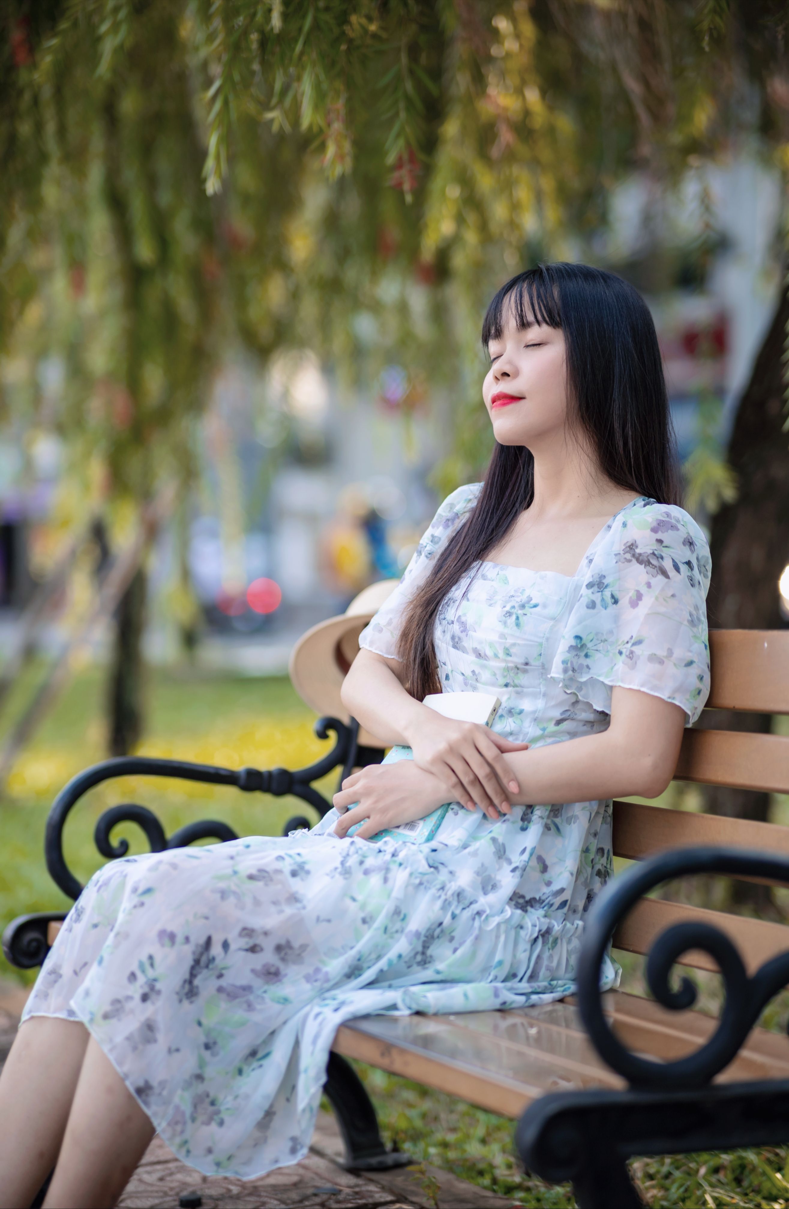 Woman Sitting on the Bench in a Park with her Eyes Closed · Free Stock ...