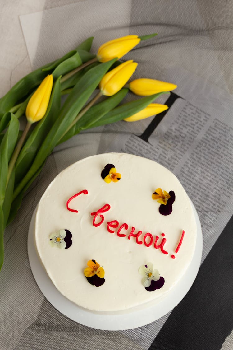 A Birthday Cake And A Bunch Of Flowers 