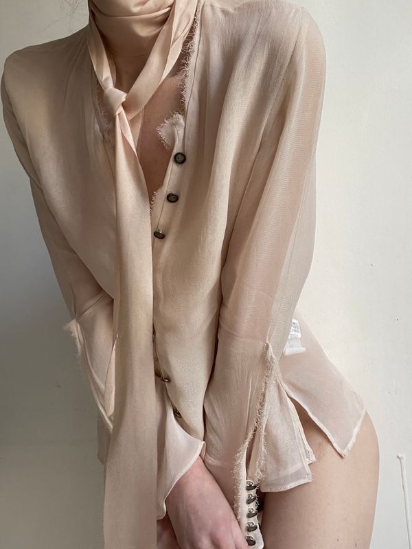 Loose silk shirt falling open over bare shoulders — Eugenia Remark on Pexels