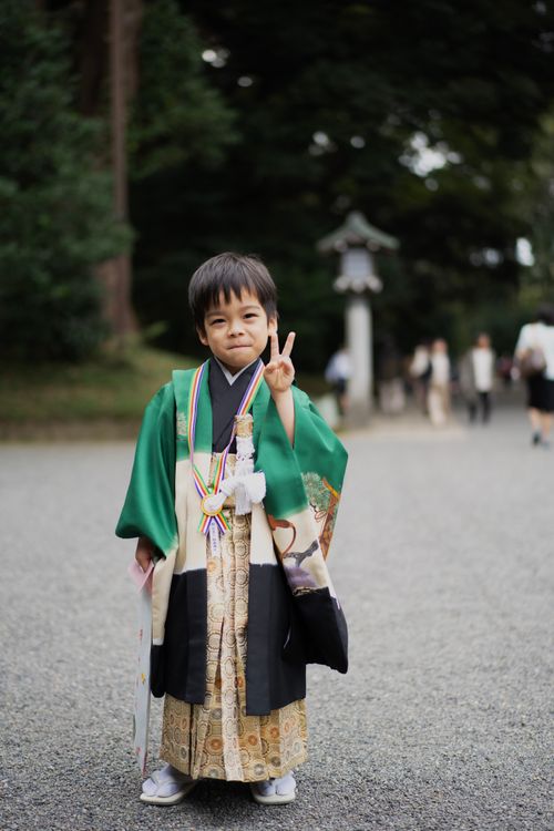 Free Young boy in traditional clothing making a peace sign in Tokyo, Japan. Stock Photo