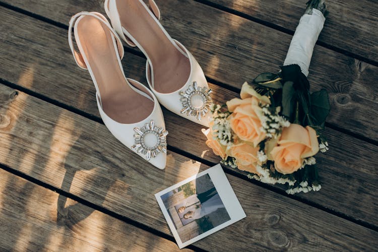 Bridal Shoes, Bouquet And A Polaroid Picture On The Ground 