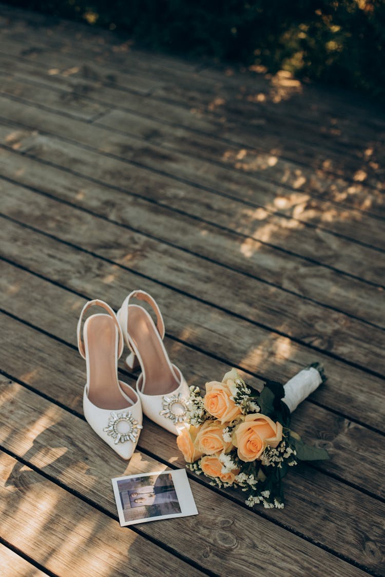 Bridal Shoes, Bouquet And A Polaroid Picture On The Ground 