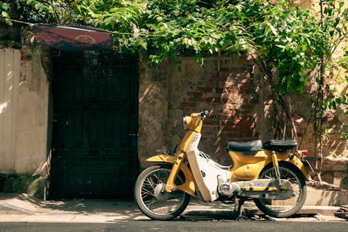 Yellow Motor Scooter on Street