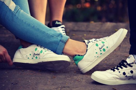 Group of individuals lounging outdoors in stylish casual sneakers.