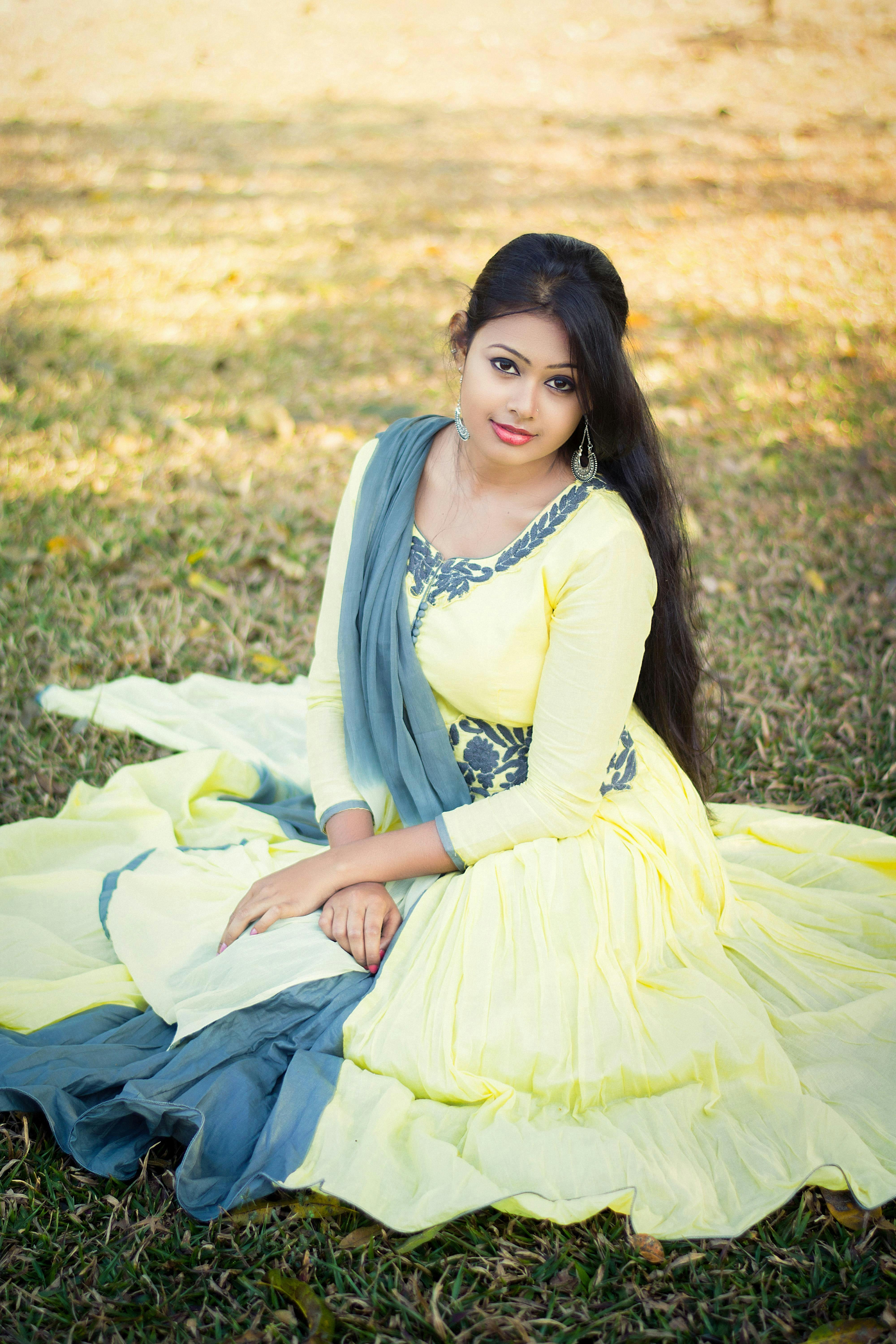 Suza poses in a traditional dress during a photoshoot