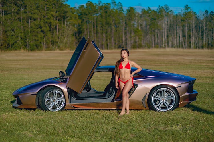 Woman Standing Next To Sporting Car