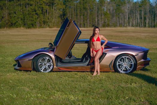 Woman Standing next to Luxury Car