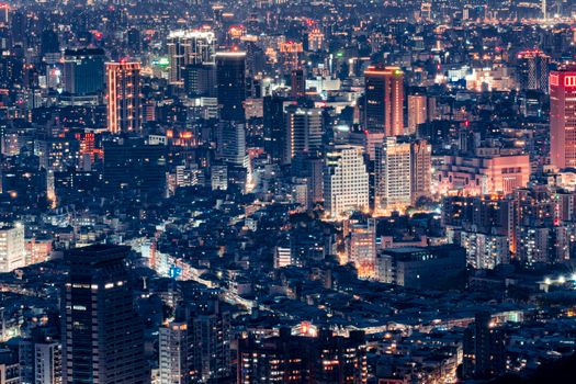 A breathtaking view of a bustling cityscape at night, showcasing illuminated skyscrapers and vibrant streets.