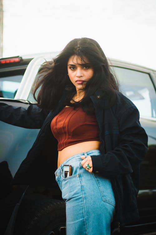 Beautiful Brunette Woman in Black Jacket and Jeans