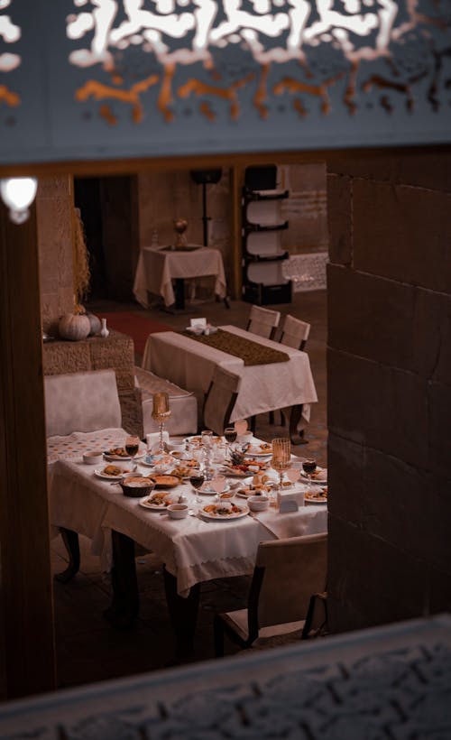 Table Full of Food in a Restaurant Photographed from the Outside 