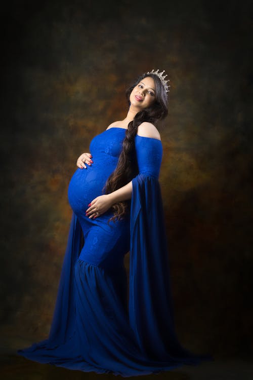 Smiling Pregnant Woman in Long Blue Dress