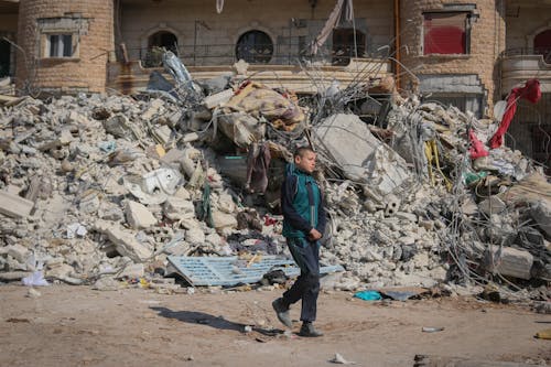 Boy Walking in Urban Ruins