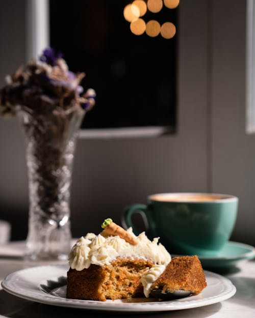 Close-up of a Slice of Cake and a Cup of Coffee on a Table