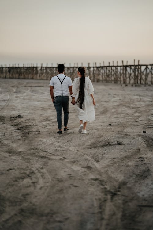 Couple Walk on Beach with Holding Hands