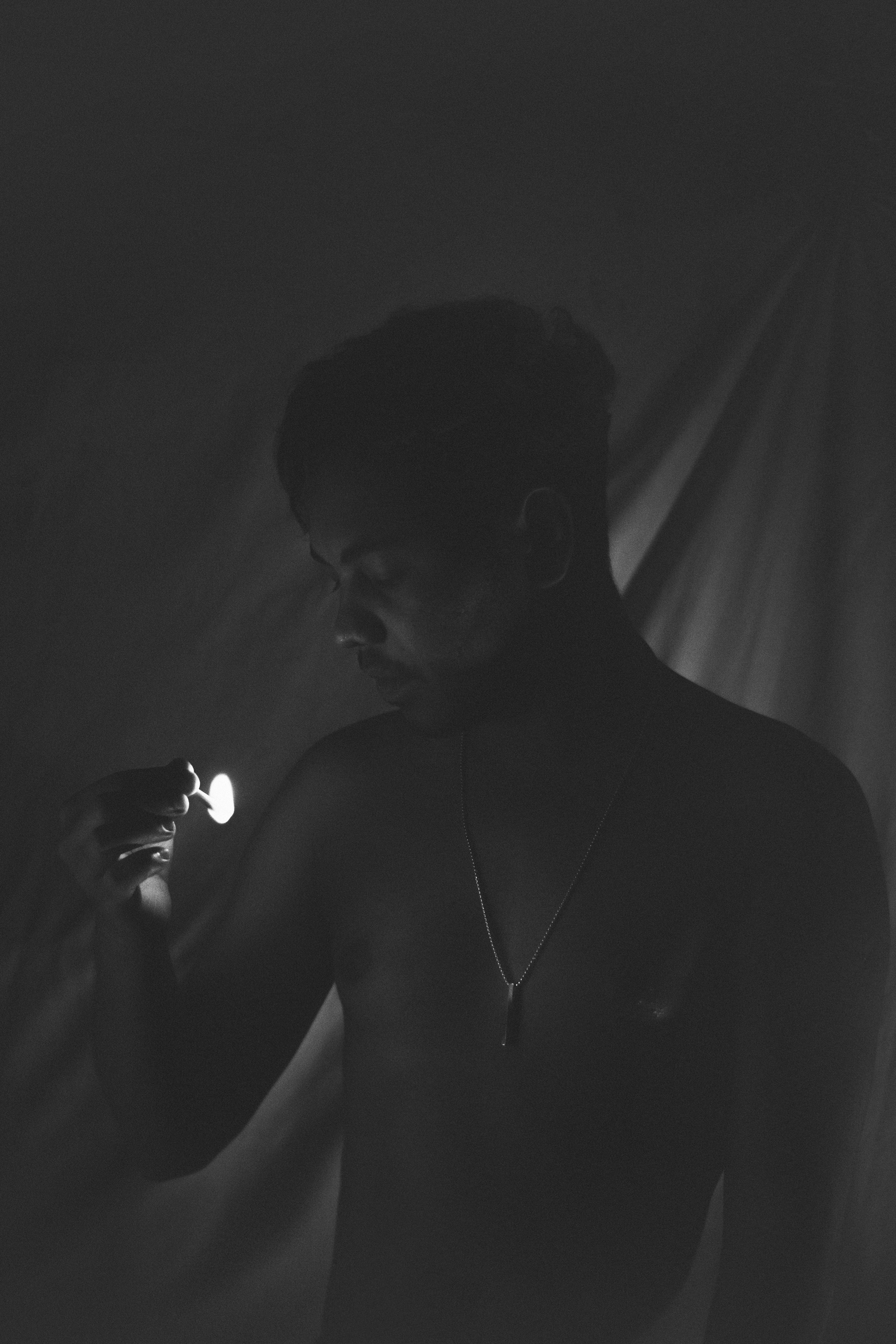 A man holding a light in his hand · Free Stock Photo