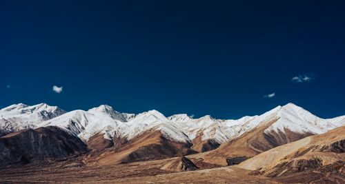 Free Breathtaking view of snow-capped mountains under a clear blue sky in winter. Stock Photo