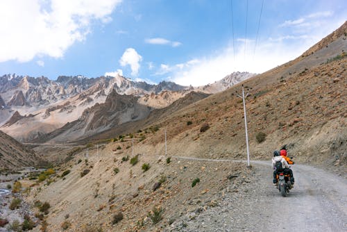 Free People on a Motorbike on a Mountain Road  Stock Photo