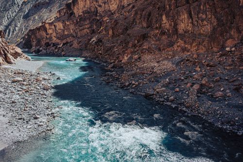 Free A picturesque river flows through a rocky gorge in Ladakheda, capturing the serene beauty of nature. Stock Photo