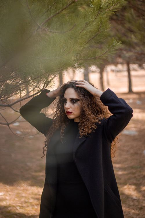 Free Model with curly hair posing in nature, Niğde, Türkiye. Fashion photography, daytime setting. Stock Photo