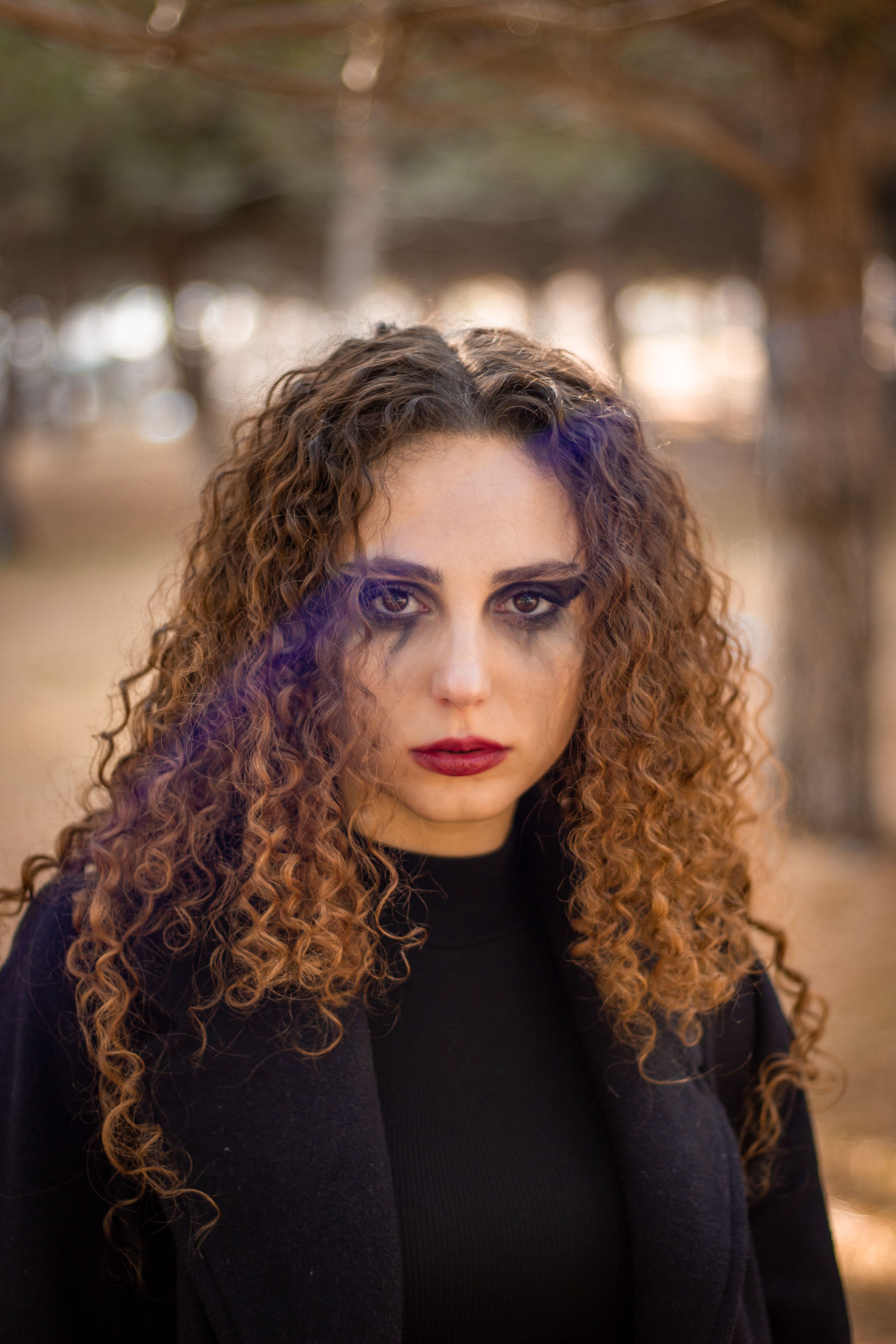 Portrait of Woman with Brown, Curly Hair · Free Stock Photo