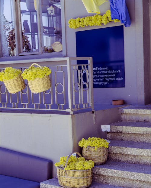 Yellow Flowers in Basket on Porch