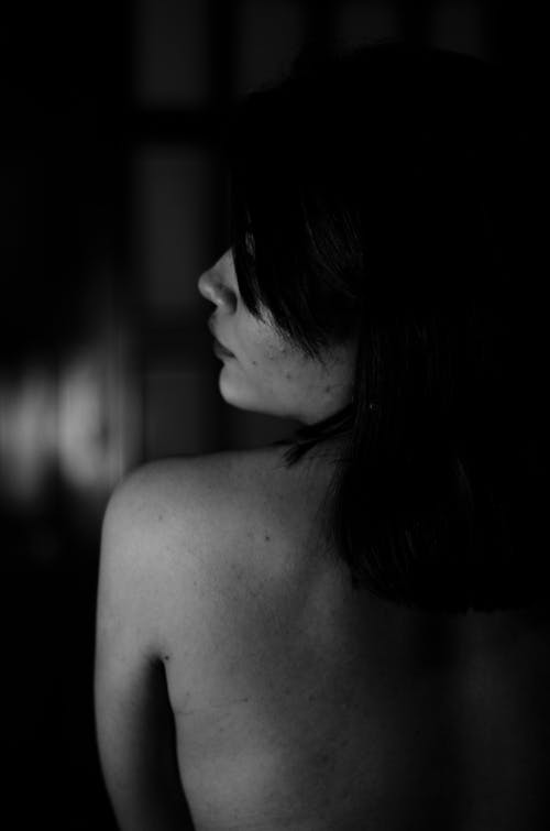 Black and White Back View of a Young Topless Woman 