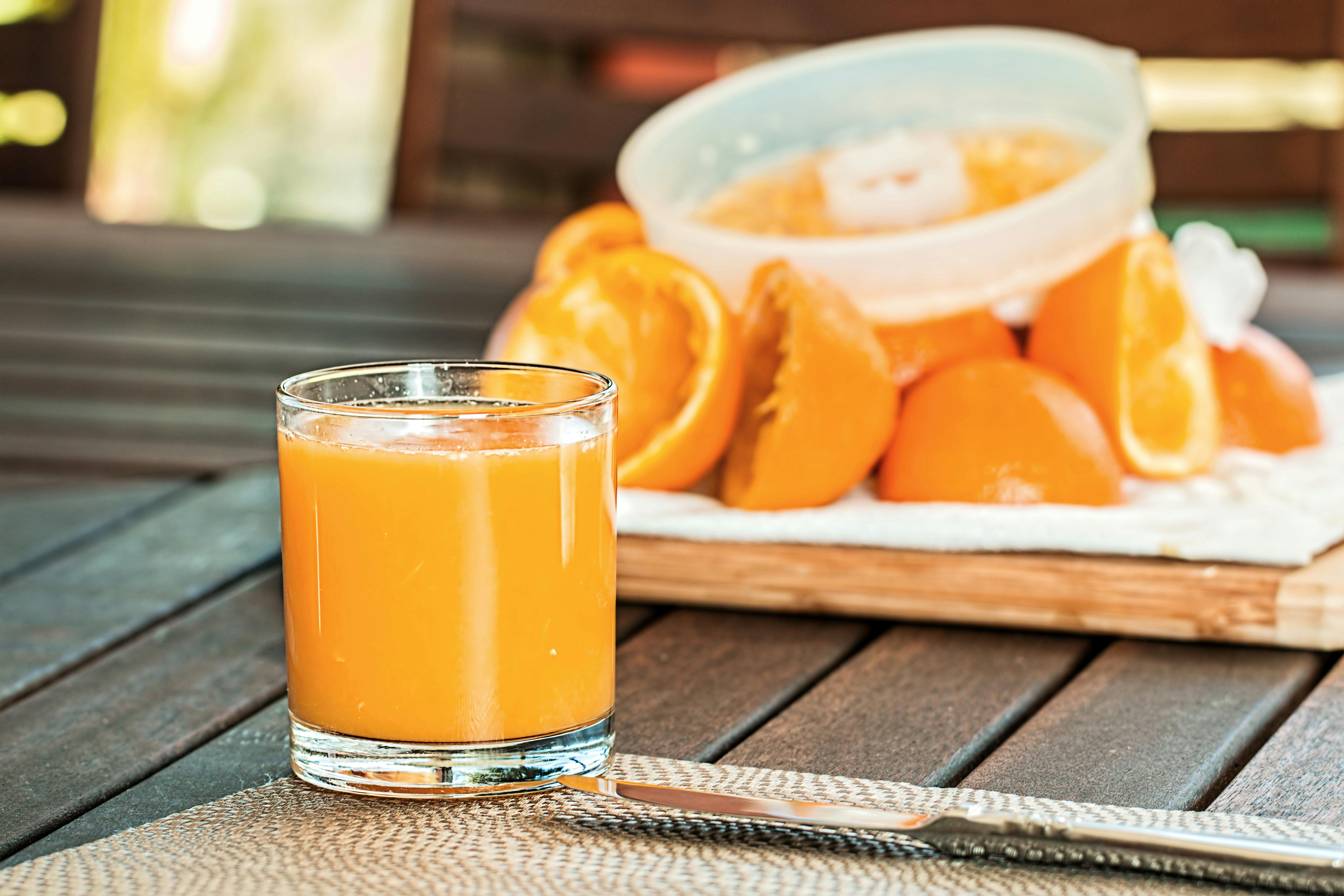 orange juice and water in pitcher on plate, Stock image