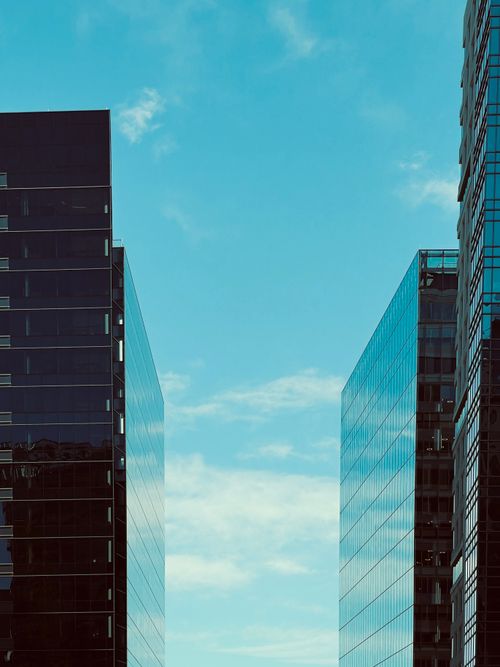 Free High-rise modern buildings with a clear blue sky backdrop, ideal for urban concepts. Stock Photo