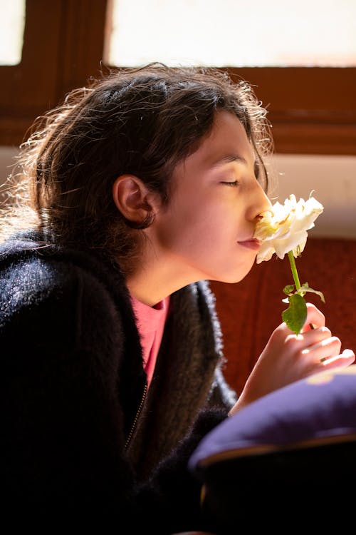 Woman Enjoying the Scent of a Flower