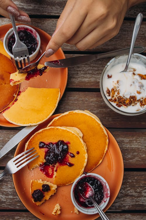 Free Hands of a Woman Eating Pancakes Stock Photo